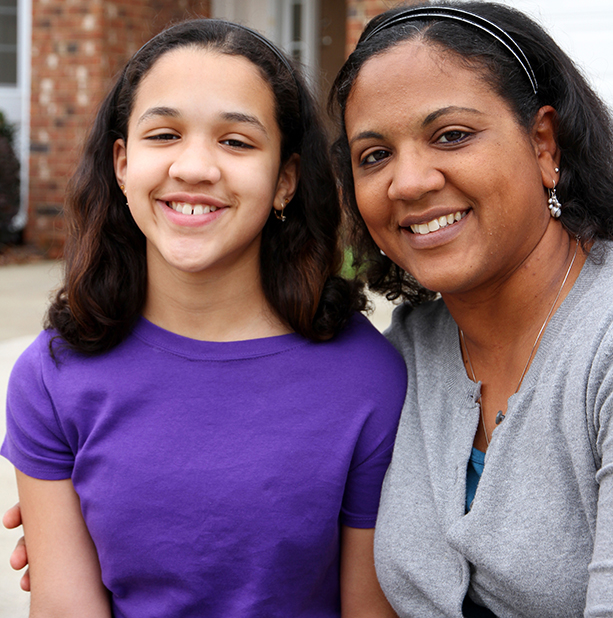 A mixed race mother and daughter at their home
